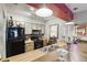 Well-lit kitchen featuring black appliances, mosaic backsplash, breakfast bar, and pendant lighting at 1005 Love Ln # 25, Apopka, FL 32703