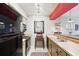 Compact kitchen featuring stainless steel sink, butcher block countertops, and black appliances at 1005 Love Ln # 25, Apopka, FL 32703