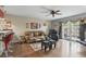 Spacious living room featuring hardwood floors, a ceiling fan, and a glass-paneled door to the outside at 1005 Love Ln # 25, Apopka, FL 32703