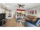 Bright living room with open layout, hardwood floors, bar seating, and access to the kitchen at 1005 Love Ln # 25, Apopka, FL 32703