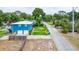 Aerial view showcasing the blue two-story home, well-maintained lawn, and a fenced yard in a serene setting at 1046 Blackwood St, Altamonte Springs, FL 32701