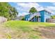 Spacious backyard with mature trees, a beautiful pool, a patio area, and a well-kept lawn at 1046 Blackwood St, Altamonte Springs, FL 32701