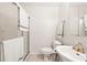 Bright bathroom featuring a shower with glass doors, a toilet, and a sink with a mirror and towel rack at 1046 Blackwood St, Altamonte Springs, FL 32701