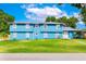 Inviting two-story home featuring a well-maintained lawn and a charming blue exterior at 1046 Blackwood St, Altamonte Springs, FL 32701