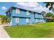 Light-blue home with a manicured lawn, white trim, and a paved driveway leading to the garage at 1046 Blackwood St, Altamonte Springs, FL 32701