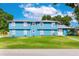 A charming light-blue two-story home featuring a well-manicured lawn and a metallic gray roof at 1046 Blackwood St, Altamonte Springs, FL 32701