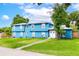 Charming blue home with a manicured lawn and a concrete walkway leading to the front door at 1046 Blackwood St, Altamonte Springs, FL 32701