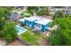 This house has blue siding, a white roof, a swimming pool, a deck, and a large manicured backyard at 1046 Blackwood St, Altamonte Springs, FL 32701