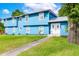 Brightly painted two-story home with lush green lawn and sidewalk leading to a double-door entry at 1046 Blackwood St, Altamonte Springs, FL 32701