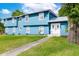 Close-up view of a light-blue house featuring a well-kept lawn and a double-door entrance at 1046 Blackwood St, Altamonte Springs, FL 32701