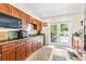Traditional kitchen with granite countertops, wooden cabinets, and stainless steel appliances at 1046 Blackwood St, Altamonte Springs, FL 32701