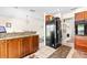 Kitchen area with wood cabinets, granite countertops, and black refrigerator at 1046 Blackwood St, Altamonte Springs, FL 32701
