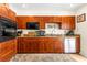 Traditional kitchen featuring wood cabinets, granite countertops, and stainless steel dishwasher at 1046 Blackwood St, Altamonte Springs, FL 32701