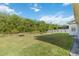 Expansive, well-maintained backyard with lush green grass and mature trees at 10626 Bonne Chance Dr, Orlando, FL 32832