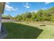 Expansive backyard with lush green grass, partial fencing, and mature trees providing privacy at 10626 Bonne Chance Dr, Orlando, FL 32832