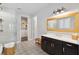 Bright primary bathroom featuring double vanity, glass enclosed shower, and walk in closet at 10626 Bonne Chance Dr, Orlando, FL 32832