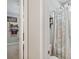 Bathroom featuring shower with decorative curtain and open shelving at 10626 Bonne Chance Dr, Orlando, FL 32832