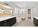 Bright primary bathroom featuring double vanity, soaking tub, and glass enclosed shower at 10626 Bonne Chance Dr, Orlando, FL 32832