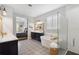 Bright primary bathroom featuring soaking tub, glass enclosed shower, and view to main bedroom at 10626 Bonne Chance Dr, Orlando, FL 32832