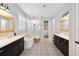 Bright primary bathroom featuring double vanity, soaking tub, and glass enclosed shower at 10626 Bonne Chance Dr, Orlando, FL 32832