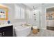 Bright primary bathroom featuring soaking tub, glass enclosed shower, and walk in closet at 10626 Bonne Chance Dr, Orlando, FL 32832