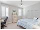Bright bedroom with white trim, neutral walls and ceiling, and modern light fixture at 10626 Bonne Chance Dr, Orlando, FL 32832