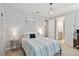 Bedroom with neutral walls, a modern light fixture, and access to a bathroom at 10626 Bonne Chance Dr, Orlando, FL 32832