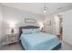 Comfortable bedroom with a blue bedspread, matching lamps, and soft, neutral carpet at 10626 Bonne Chance Dr, Orlando, FL 32832