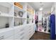 Bright walk-in closet with custom storage, shelving, drawers, and room for clothing and accessories at 10626 Bonne Chance Dr, Orlando, FL 32832
