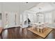 Bright dining room with modern chandelier, white table and chairs, and view into office space at 10626 Bonne Chance Dr, Orlando, FL 32832