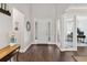 Bright foyer featuring hardwood floors, a white front door with sidelights, and views into the home office at 10626 Bonne Chance Dr, Orlando, FL 32832