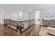 Hallway with hard wood flooring and iron railing at 10626 Bonne Chance Dr, Orlando, FL 32832