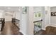 Bright hallway with hardwood floors, wrought iron railing and wall decor at 10626 Bonne Chance Dr, Orlando, FL 32832