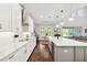Bright kitchen featuring white cabinets, spacious island, and view of the breakfast nook at 10626 Bonne Chance Dr, Orlando, FL 32832