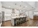 Modern kitchen with white cabinets, stainless steel appliances, large island, and pendant lighting at 10626 Bonne Chance Dr, Orlando, FL 32832