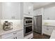 Modern kitchen with stainless steel appliances, and sleek white cabinets at 10626 Bonne Chance Dr, Orlando, FL 32832
