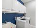Modern laundry room with white cabinets and sink at 10626 Bonne Chance Dr, Orlando, FL 32832