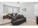 Comfortable living room featuring neutral walls, plush gray sofas, and bright light fixtures at 10626 Bonne Chance Dr, Orlando, FL 32832
