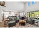 Bright, open living space with a large sectional sofa, colorful rug, and views into the kitchen at 10626 Bonne Chance Dr, Orlando, FL 32832