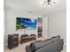 Spacious living room featuring a modern TV, gray sofa, and unique ceiling light at 10626 Bonne Chance Dr, Orlando, FL 32832