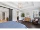 Spacious main bedroom with ensuite bath, walk-in closet, decorative lighting, and tray ceiling at 10626 Bonne Chance Dr, Orlando, FL 32832