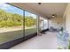Covered patio with outdoor seating and screened enclosure overlooking fenced backyard at 10626 Bonne Chance Dr, Orlando, FL 32832