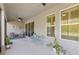 Covered patio with outdoor seating, ceiling fan, and large windows at 10626 Bonne Chance Dr, Orlando, FL 32832