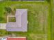 Aerial view of the home shows its backyard, roof, and nearby landscaping at 107 Carlisle Ct, Kissimmee, FL 34758