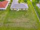 An aerial view of the home, its backyard, and its adjacent properties at 107 Carlisle Ct, Kissimmee, FL 34758