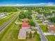 Aerial view of neighborhood, showing the home and neighboring residences near a main road at 107 Carlisle Ct, Kissimmee, FL 34758
