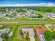 Aerial view of neighborhood, showing the home and neighboring residences near a main road at 107 Carlisle Ct, Kissimmee, FL 34758