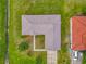 Aerial view of the home shows its backyard, roof, and nearby landscaping at 107 Carlisle Ct, Kissimmee, FL 34758