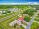 Aerial view of neighborhood, showing the home and neighboring residences near a main road at 107 Carlisle Ct, Kissimmee, FL 34758