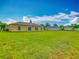 A beautiful green lawn makes up the backyard, extending from the home to the other properties at 107 Carlisle Ct, Kissimmee, FL 34758